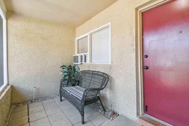 8030 San Bernardino Dr, Port Richey, FL 34668 - property entrance featuring stucco siding and cooling unit