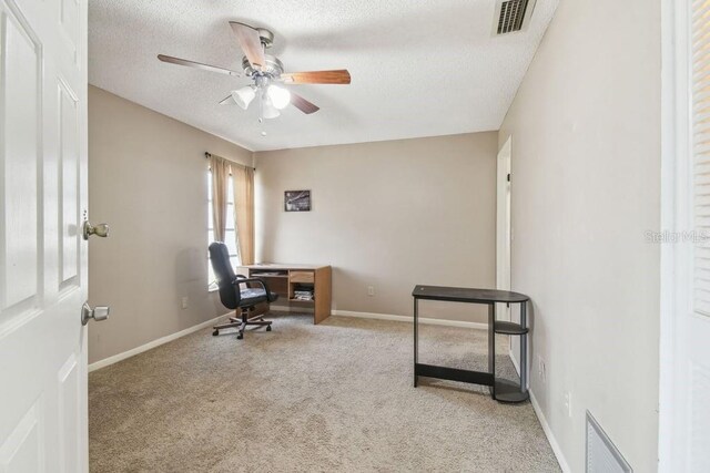 8030 San Bernardino Dr, Port Richey, FL 34668 - office area featuring carpet flooring, a ceiling fan, and a textured ceiling