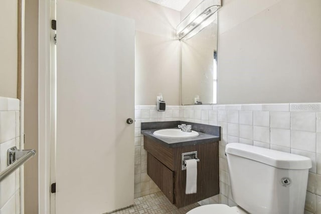 8030 San Bernardino Dr, Port Richey, FL 34668 - bathroom featuring vanity, tile walls, and wainscoting