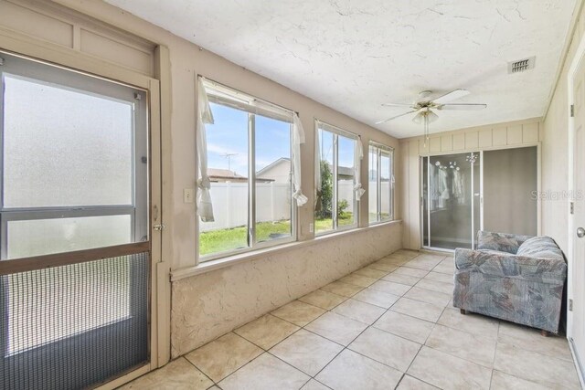 8030 San Bernardino Dr, Port Richey, FL 34668 - sunroom featuring a ceiling fan