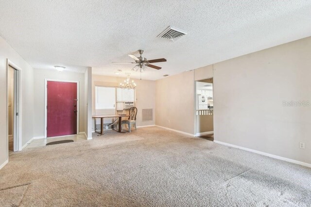 8030 San Bernardino Dr, Port Richey, FL 34668 - unfurnished living room featuring a chandelier, a textured ceiling, ceiling fan, and carpet flooring