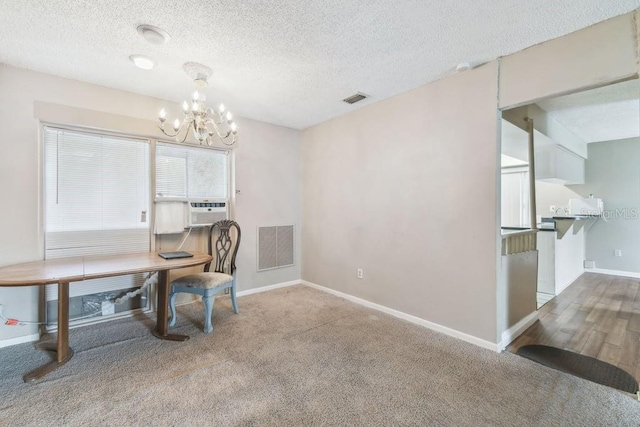 8030 San Bernardino Dr, Port Richey, FL 34668 - dining space with a chandelier, cooling unit, carpet flooring, and a textured ceiling