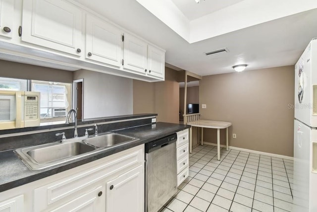 8030 San Bernardino Dr, Port Richey, FL 34668 - kitchen featuring white appliances, dark countertops, white cabinetry, and light tile patterned floors