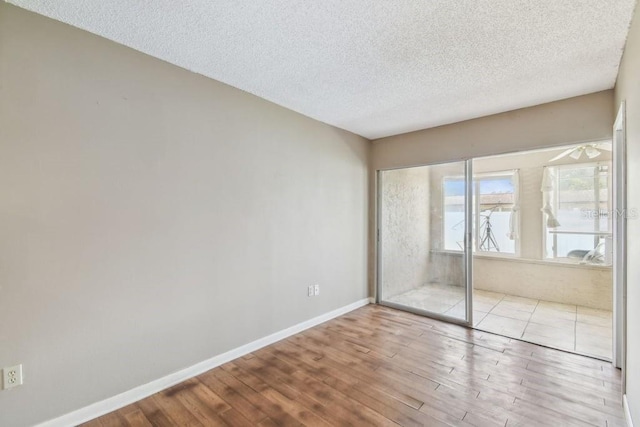 8030 San Bernardino Dr, Port Richey, FL 34668 - unfurnished bedroom with wood finished floors, a textured ceiling, and a closet