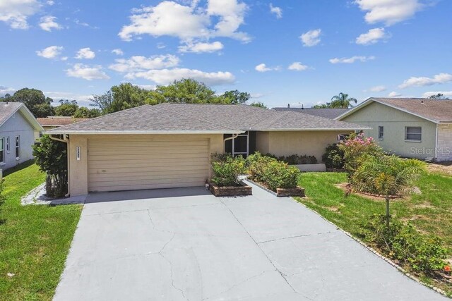 8030 San Bernardino Dr, Port Richey, FL 34668 - ranch-style home with a garage, stucco siding, concrete driveway, and a front yard
