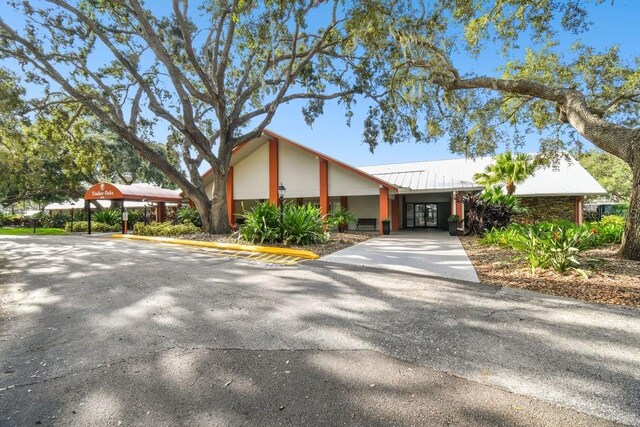 8030 San Bernardino Dr, Port Richey, FL 34668 - view of front of house with a metal roof