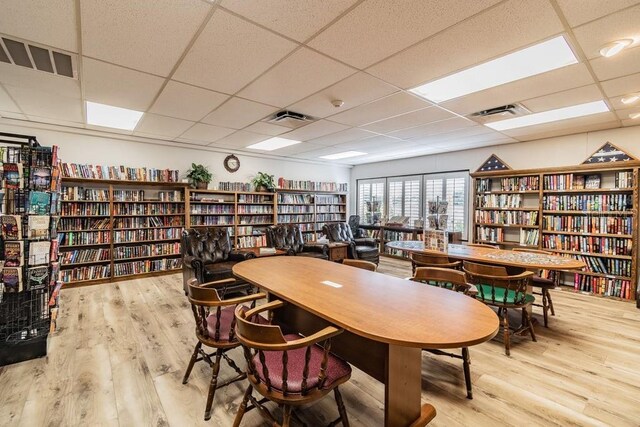 8030 San Bernardino Dr, Port Richey, FL 34668 - dining space featuring wood finished floors and a paneled ceiling