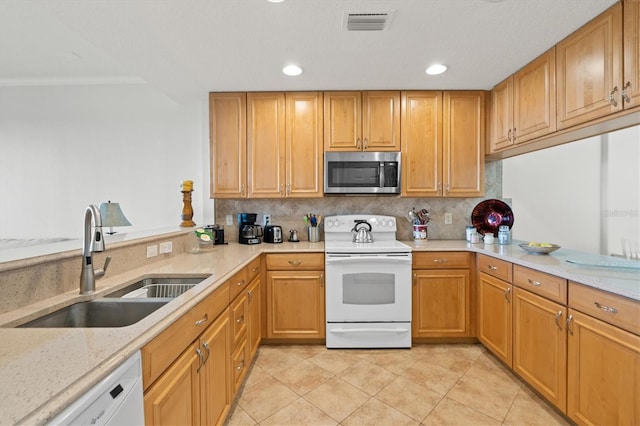 7296 Marathon Dr Unit 603, Seminole, FL 33777 - kitchen with white appliances, backsplash, light tile patterned flooring, recessed lighting, and light stone countertops