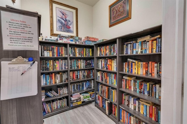 7296 Marathon Dr Unit 603, Seminole, FL 33777 - living area with wall of books and wood finished floors