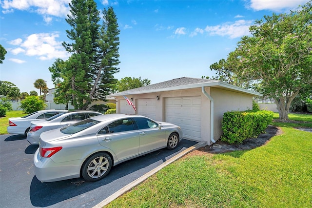 2182 Corinne Ct S Unit C, Saint Petersburg, FL 33712 - view of property exterior with a yard, stucco siding, and a garage