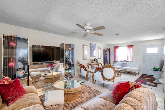 2182 Corinne Ct S Unit C, Saint Petersburg, FL 33712 - living room featuring a ceiling fan, tile patterned floors, and a textured ceiling