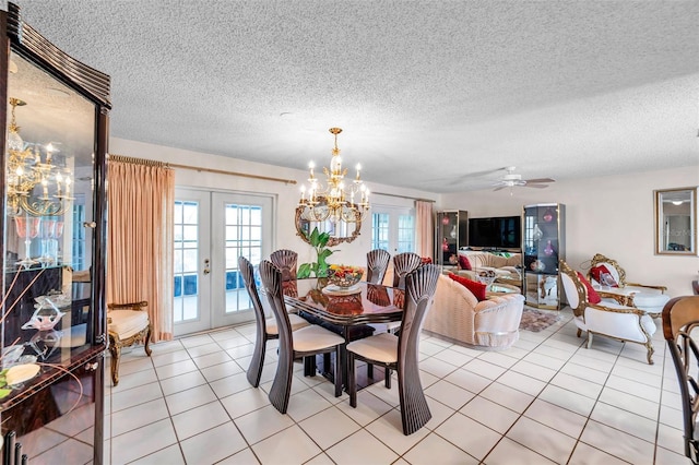 2182 Corinne Ct S Unit C, Saint Petersburg, FL 33712 - dining area featuring french doors, a chandelier, plenty of natural light, and a textured ceiling