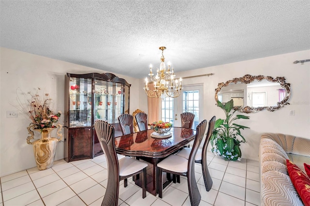 2182 Corinne Ct S Unit C, Saint Petersburg, FL 33712 - dining room with a chandelier, light tile patterned floors, and a textured ceiling