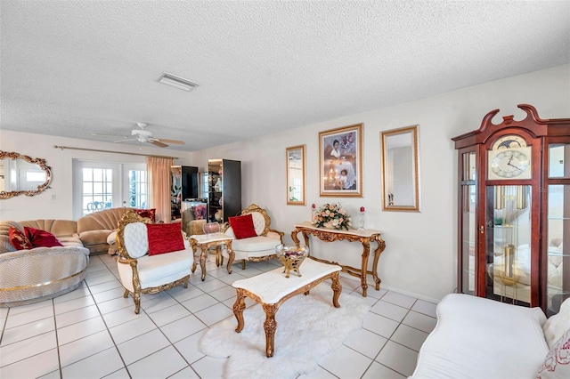 2182 Corinne Ct S Unit C, Saint Petersburg, FL 33712 - living area featuring light tile patterned flooring, a textured ceiling, and a ceiling fan