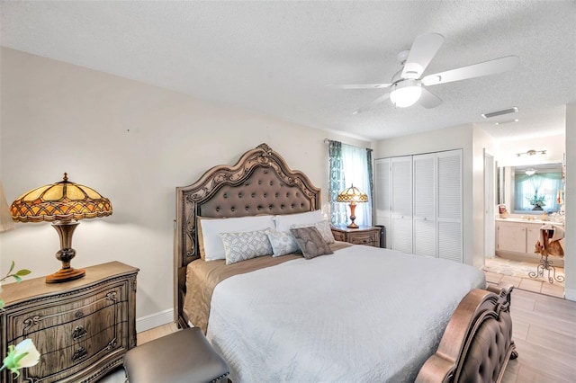 2182 Corinne Ct S Unit C, Saint Petersburg, FL 33712 - bedroom with a textured ceiling, a closet, a ceiling fan, and ensuite bathroom