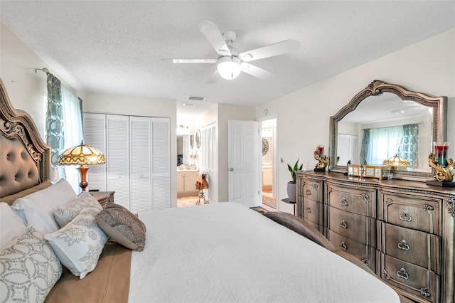 2182 Corinne Ct S Unit C, Saint Petersburg, FL 33712 - bedroom featuring a textured ceiling, ensuite bathroom, and a ceiling fan