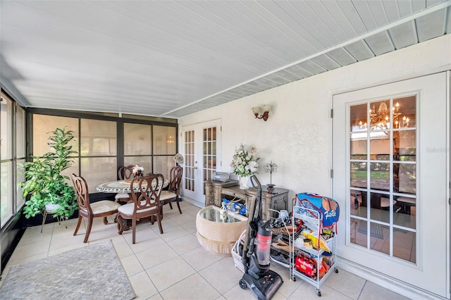 2182 Corinne Ct S Unit C, Saint Petersburg, FL 33712 - sunroom with french doors, tile patterned floors, a chandelier, and outdoor dining space