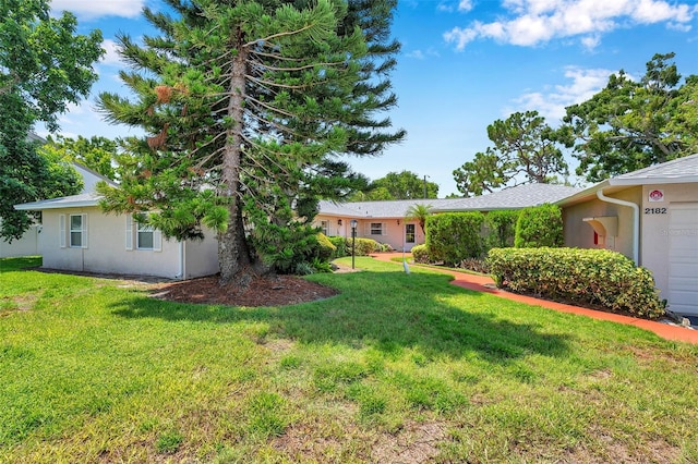 2182 Corinne Ct S Unit C, Saint Petersburg, FL 33712 - view of grassy yard featuring a garage