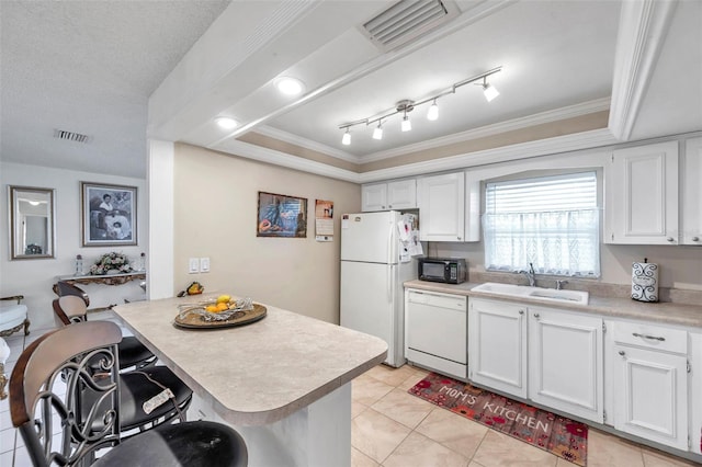 2182 Corinne Ct S Unit C, Saint Petersburg, FL 33712 - kitchen featuring white appliances, light countertops, ornamental molding, a breakfast bar, and white cabinetry