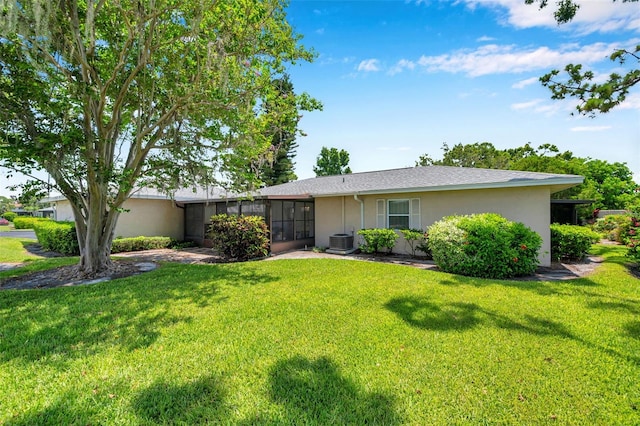 2182 Corinne Ct S Unit C, Saint Petersburg, FL 33712 - rear view of property with stucco siding, a yard, and a sunroom