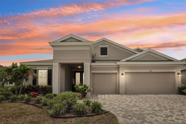 5426 Wayfarer Ave, Apollo Beach, FL 33572 - view of front of home featuring stucco siding, decorative driveway, and a garage