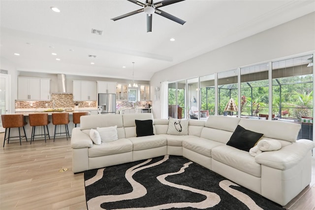 5426 Wayfarer Ave, Apollo Beach, FL 33572 - living room with light wood finished floors, a ceiling fan, recessed lighting, and a chandelier