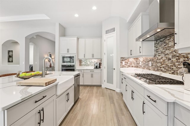 5426 Wayfarer Ave, Apollo Beach, FL 33572 - kitchen with wall chimney exhaust hood, stainless steel appliances, recessed lighting, white cabinets, and light stone countertops
