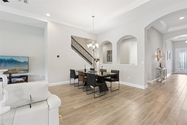 5426 Wayfarer Ave, Apollo Beach, FL 33572 - dining room with light wood-type flooring, recessed lighting, ornamental molding, arched walkways, and a chandelier