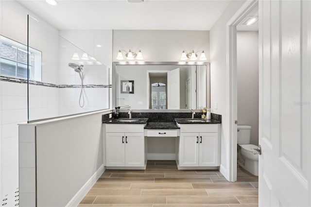 5426 Wayfarer Ave, Apollo Beach, FL 33572 - bathroom featuring walk in shower, vanity, and wood finish floors