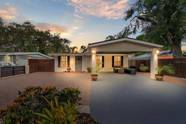 1905 E 99th Ave, Tampa, FL 33612 - view of front of house with a patio area, stucco siding, and outdoor lounge area