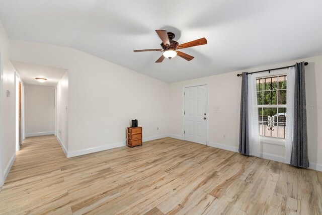 1905 E 99th Ave, Tampa, FL 33612 - spare room featuring a ceiling fan, wood finished floors, and vaulted ceiling