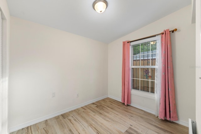 1905 E 99th Ave, Tampa, FL 33612 - unfurnished room with vaulted ceiling and light wood-style flooring