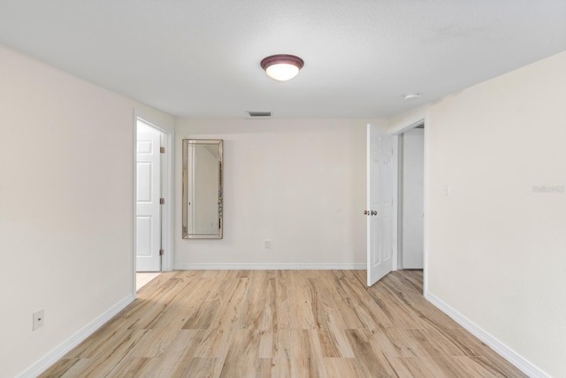 1905 E 99th Ave, Tampa, FL 33612 - empty room featuring light wood finished floors and a smoke detector