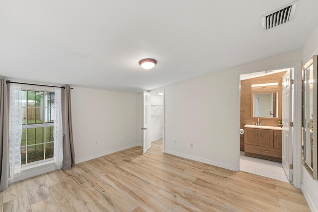 1905 E 99th Ave, Tampa, FL 33612 - unfurnished bedroom with light wood-style flooring and ensuite bath