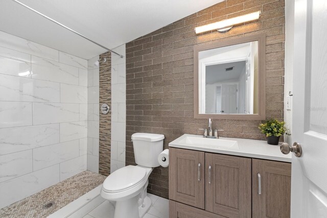 1905 E 99th Ave, Tampa, FL 33612 - full bathroom featuring vanity, a tile shower, and tile walls