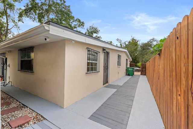 1905 E 99th Ave, Tampa, FL 33612 - view of side of home featuring stucco siding