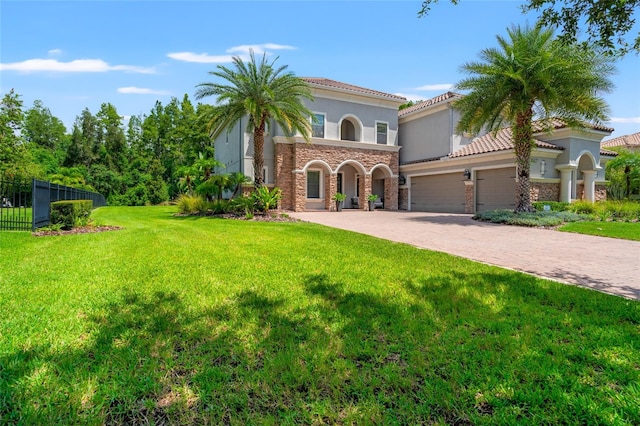 1507 Amarone Pl, Lutz, FL 33548 - mediterranean / spanish home featuring decorative driveway, stucco siding, an attached garage, and stone siding