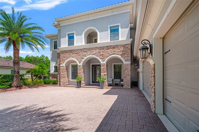 1507 Amarone Pl, Lutz, FL 33548 - view of patio featuring decorative driveway and a garage