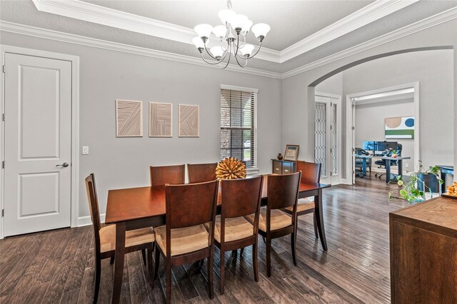 1507 Amarone Pl, Lutz, FL 33548 - dining area featuring arched walkways, dark wood finished floors, a chandelier, a raised ceiling, and crown molding