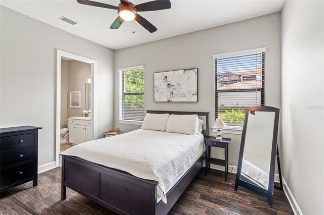 1507 Amarone Pl, Lutz, FL 33548 - bedroom featuring multiple windows, dark wood-type flooring, ensuite bath, and a ceiling fan