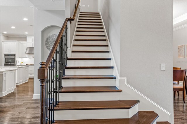 1507 Amarone Pl, Lutz, FL 33548 - staircase with wood finished floors, crown molding, recessed lighting, and a textured wall