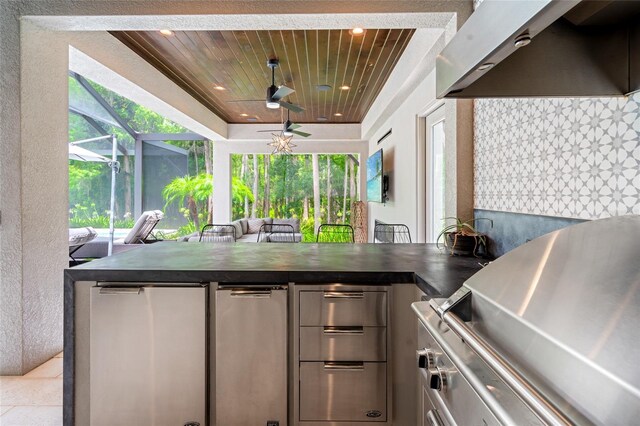 1507 Amarone Pl, Lutz, FL 33548 - kitchen with wall chimney exhaust hood, dark countertops, a ceiling fan, open floor plan, and wooden ceiling