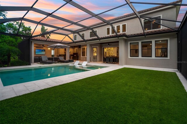1507 Amarone Pl, Lutz, FL 33548 - back of house with a patio area, a lawn, and a tiled roof