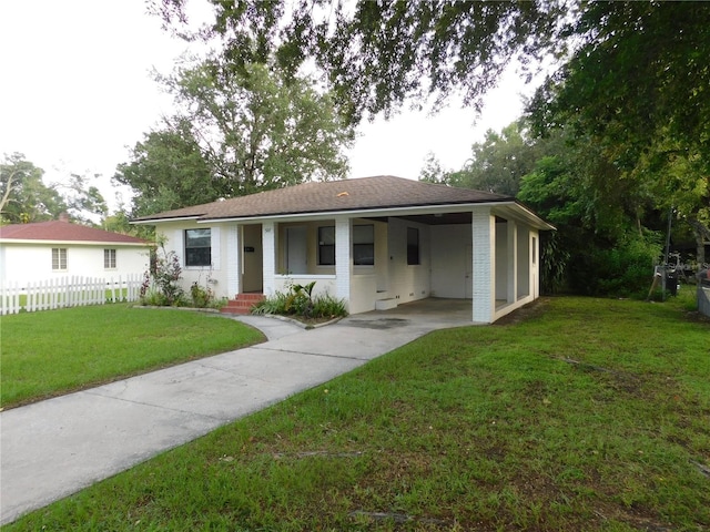 507 Francis Blvd, Lakeland, FL 33801 - ranch-style house with driveway, an attached carport, and roof with shingles