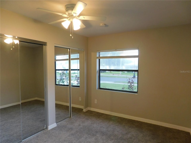 507 Francis Blvd, Lakeland, FL 33801 - unfurnished bedroom featuring two closets, carpet flooring, and ceiling fan
