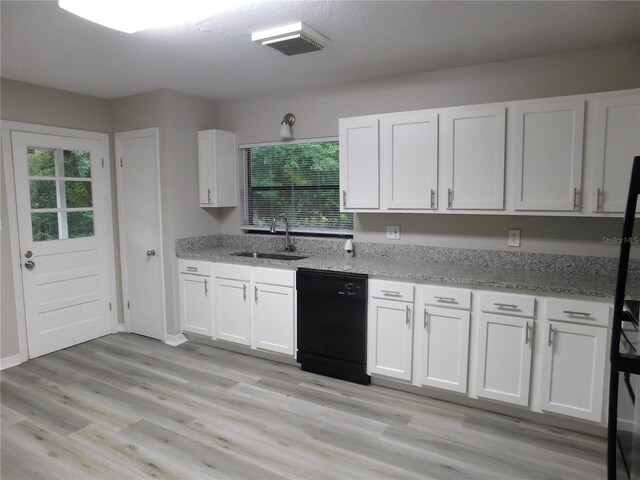 507 Francis Blvd, Lakeland, FL 33801 - kitchen featuring black dishwasher, white cabinetry, healthy amount of natural light, and light stone counters