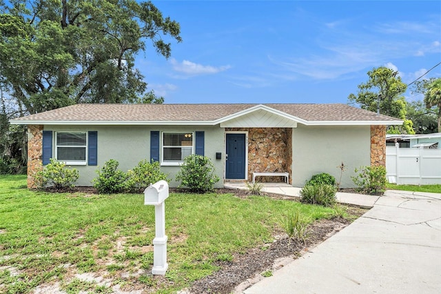 6601 N Elizabeth St, Tampa, FL 33604 - view of front of home with stone siding, stucco siding, and a shingled roof