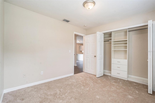 6601 N Elizabeth St, Tampa, FL 33604 - unfurnished bedroom with light colored carpet and a closet