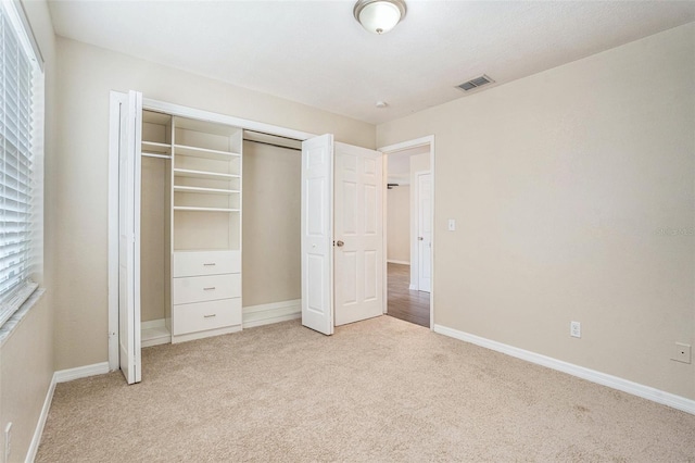 6601 N Elizabeth St, Tampa, FL 33604 - unfurnished bedroom featuring light carpet and a closet