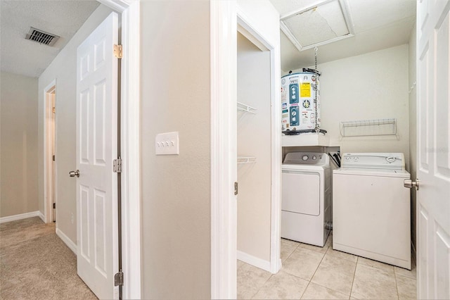 6601 N Elizabeth St, Tampa, FL 33604 - washroom featuring separate washer and dryer, light tile patterned floors, and water heater